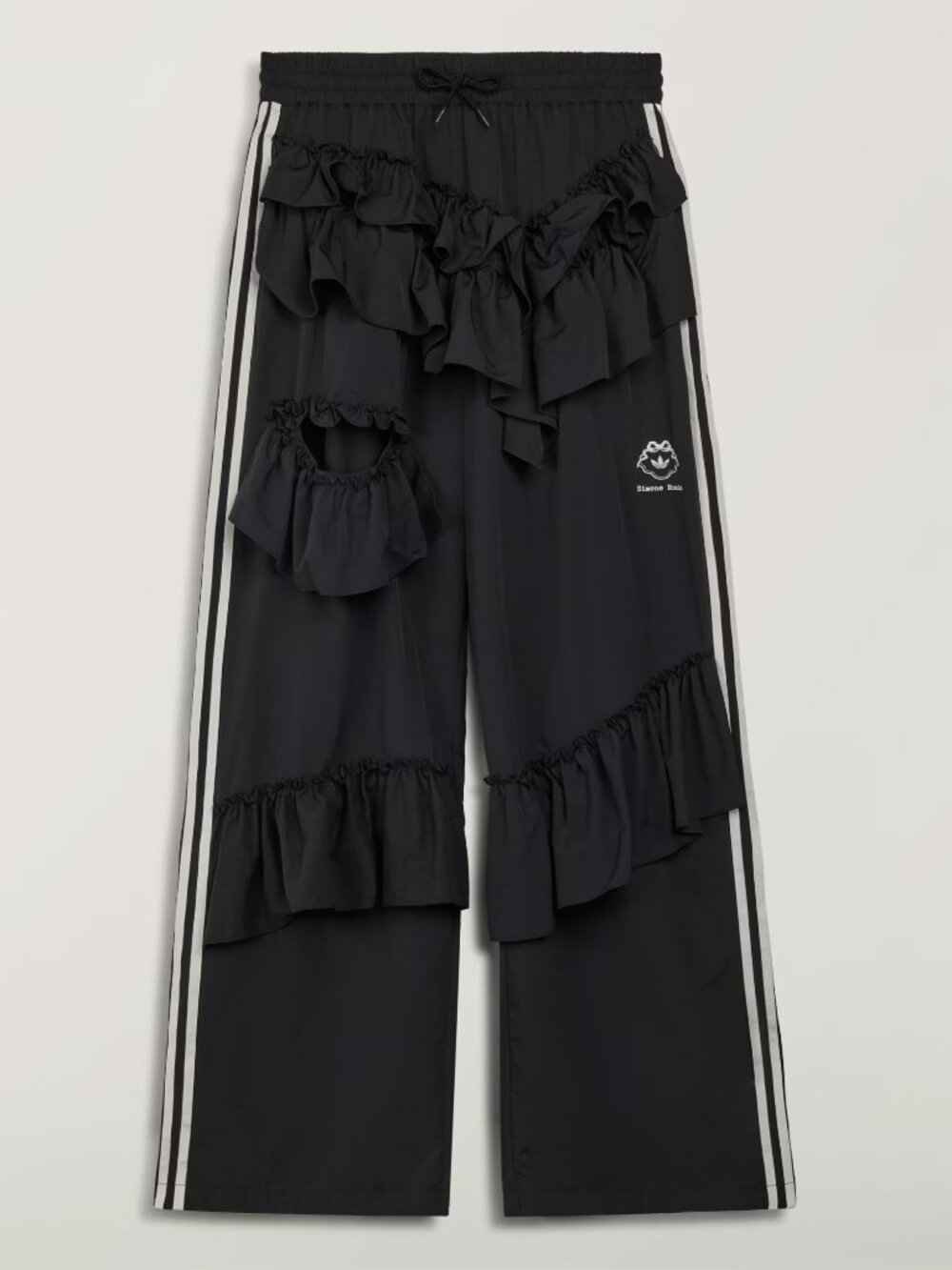 A voluminous hooded dress shaped through tiers of soft frills, with subtle asymm